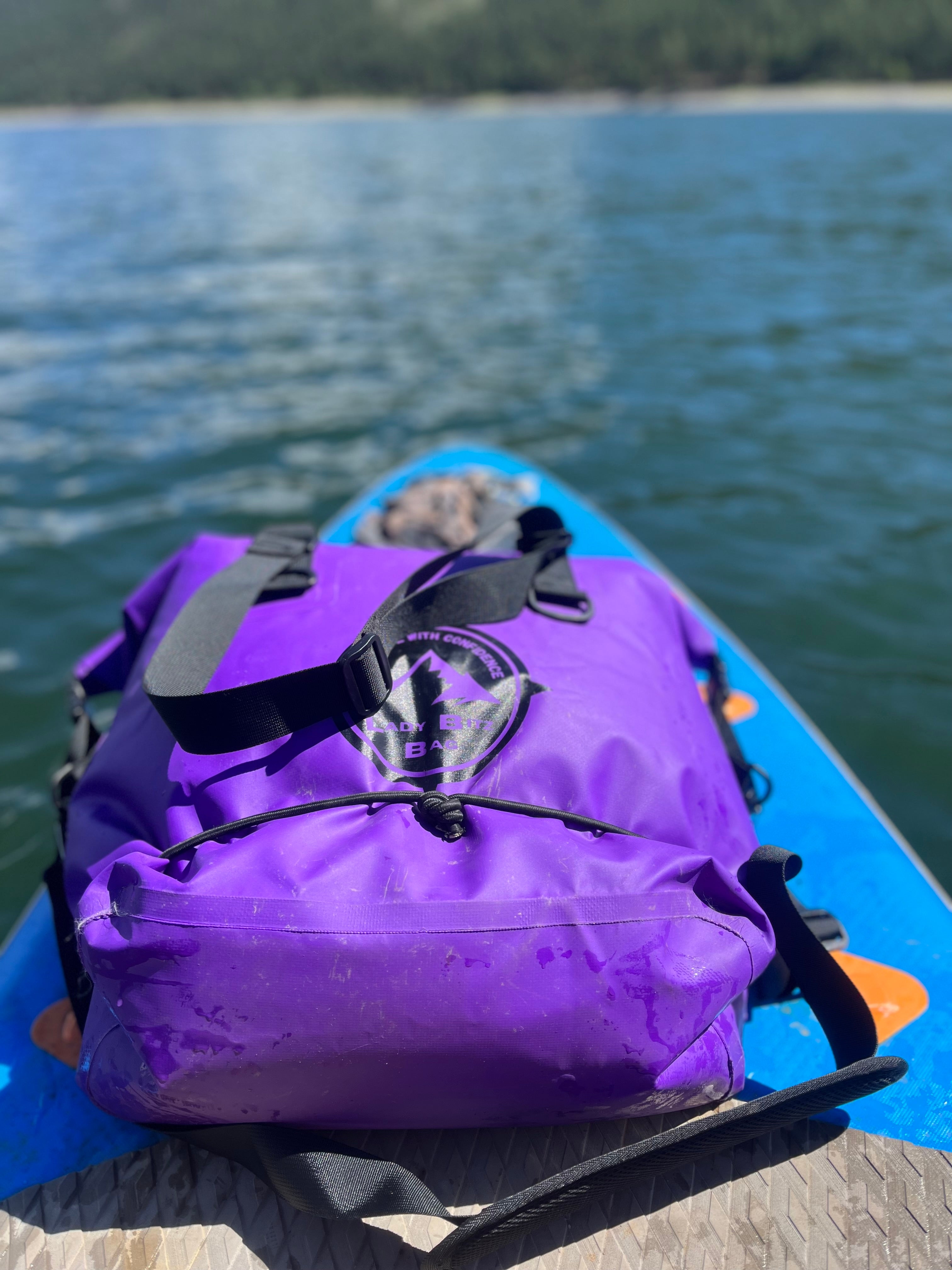 ladybitz bag on a paddle board in Vallecito, Colorado. This drybag is made for kayaking, paddleboarding, rafting and more. A versatile bag made for women.